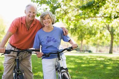 Older couple on bikes with dentures in urbandale ia
